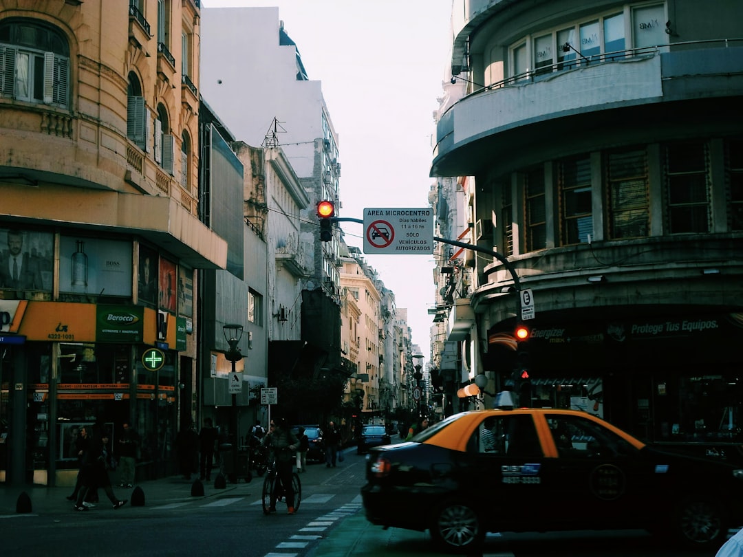 cars-on-road-between-buildings-during-daytime-yawfcp55k3w